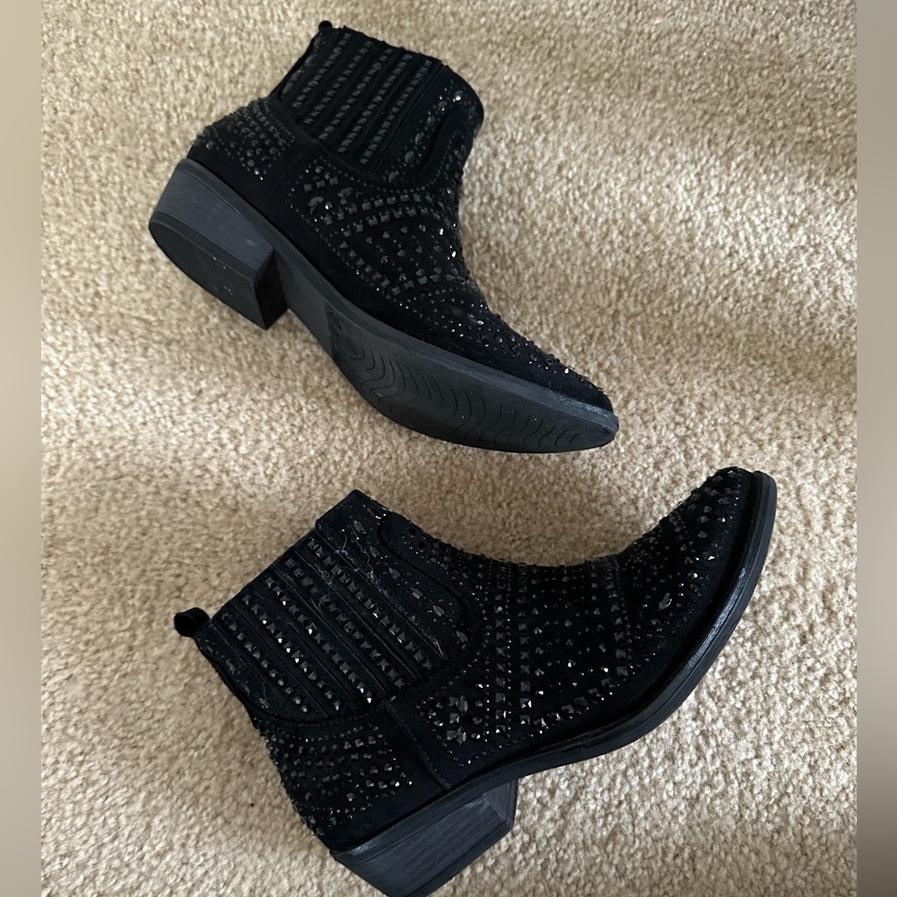 Black ankle boots have a